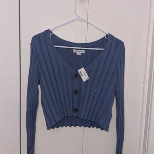 super soft button down sweater, cropped and ruffled. Can be worn off shoulder.